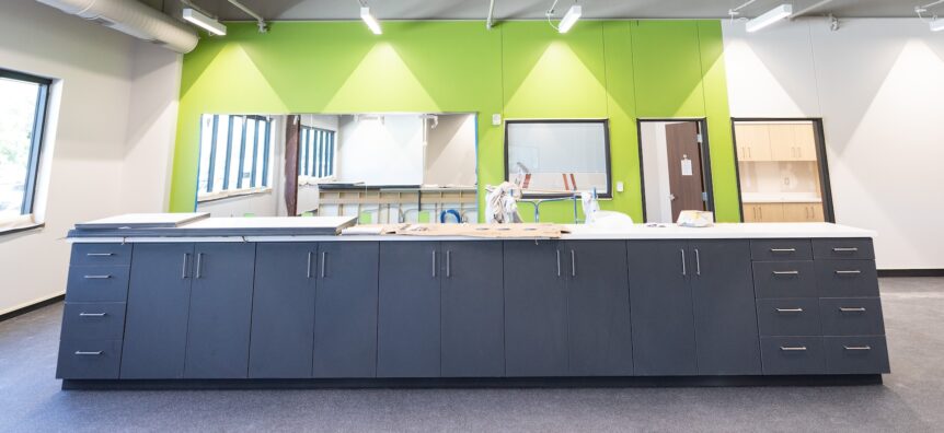 Spacious interior with custom casework and vibrant green wall color at OrthoNebraska clinic